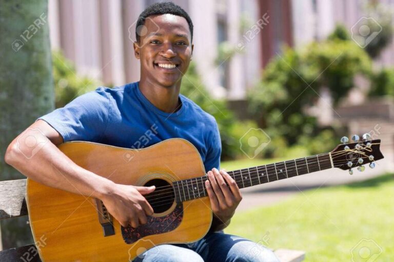 A Man Playing A Guitar